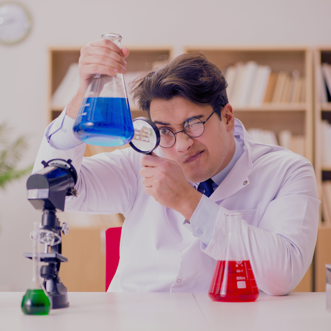 Male scientist closely examining a blue liquid in a lab beaker, symbolizing the science behind busting lube and friction myths for Happy Lube's blog.